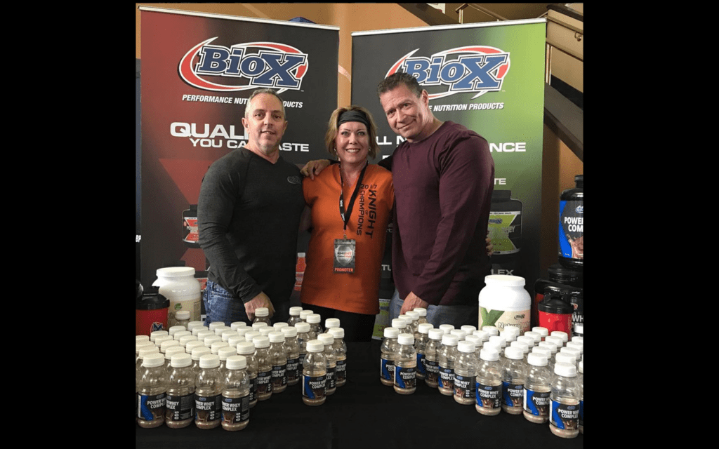 2 body builder man and 1 body builder women standing