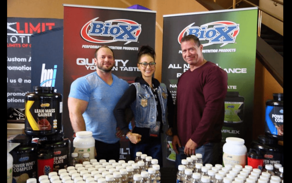 Body builders standing on a stall